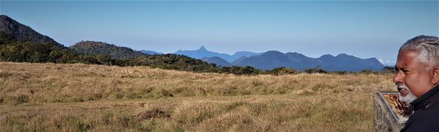 Upali pointing out Adam's Peak and other peaks on the horizon at Horton Plains  (photo copyright Mike Jarvis)